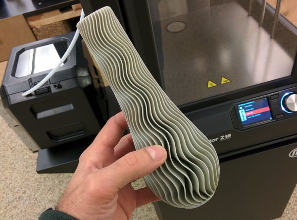 Готовое 3D-печатное изделие рядом с принтером